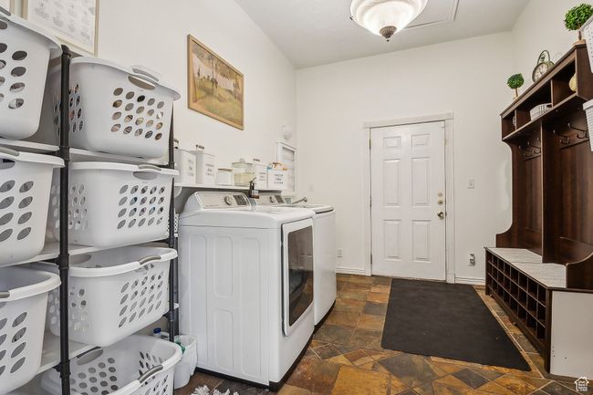 Laundry room with stone finish flooring, laundry area, and washer and clothes dryer | Image 36