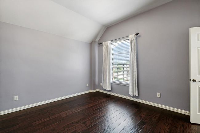 Spare room with wood-type flooring and lofted ceiling | Image 27