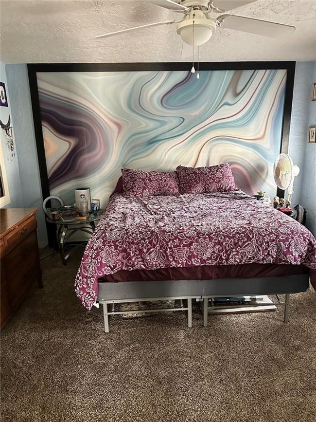 Carpeted bedroom with a ceiling fan | Image 17