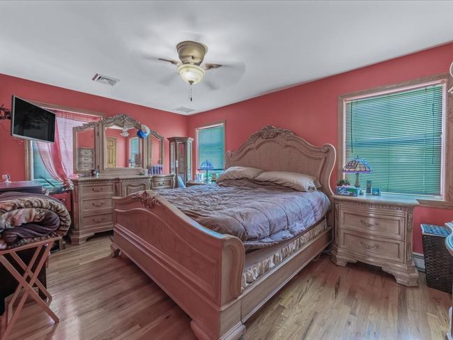 Bedroom featuring wood finished floors and ceiling fan | Image 21