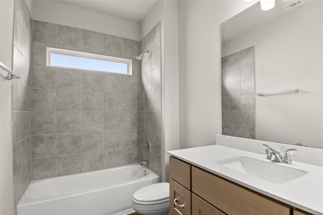 Bathroom featuring vanity, visible vents, bathtub / shower combination, and toilet | Image 22