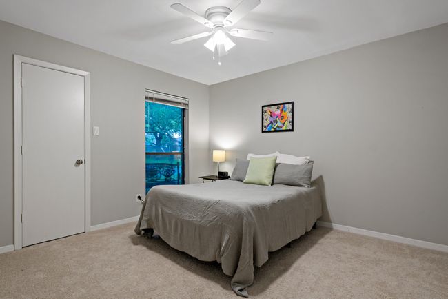 Bedroom featuring baseboards, a ceiling fan, and light carpet | Image 19
