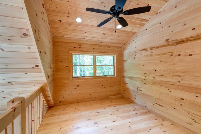 Additional living space featuring wooden walls, wood ceiling, a sauna, vaulted ceiling, and a ceiling fan | Image 19