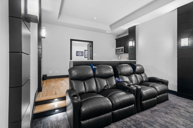 Home theater with baseboards, a raised ceiling, and wood finished floors | Image 27