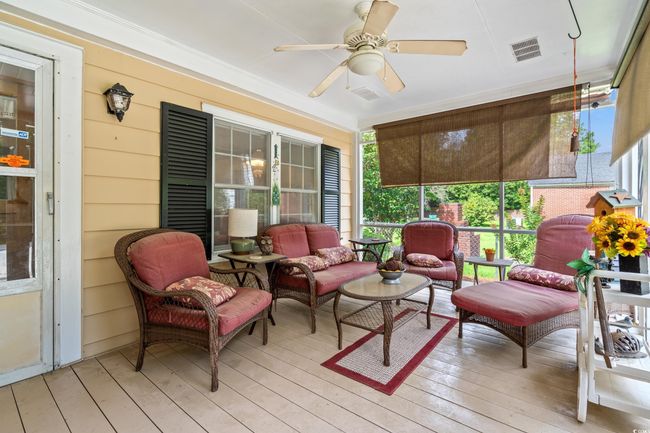 Sunroom featuring a ceiling fan, plenty of natural light, and outdoor lounge area | Image 23