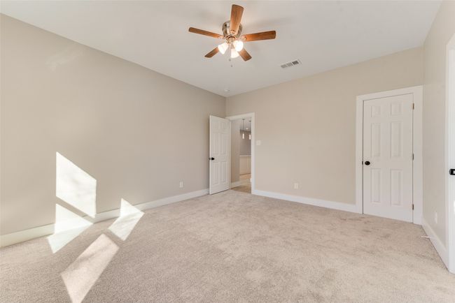 Unfurnished bedroom with light carpet and a ceiling fan | Image 25