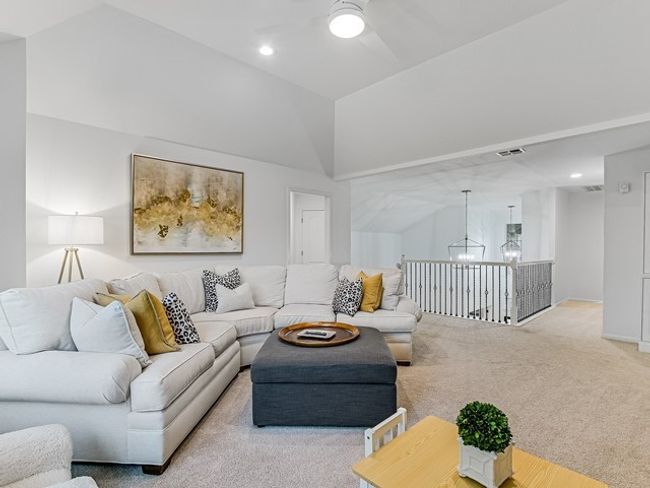 Carpeted living area with lofted ceiling, visible vents, recessed lighting, and ceiling fan with notable chandelier | Image 14