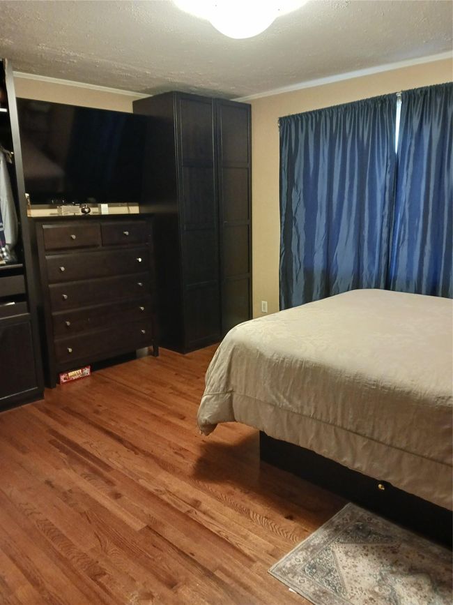 Bedroom featuring wood finished floors | Image 14
