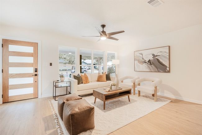 Living area with ceiling fan and light wood-type flooring | Image 5