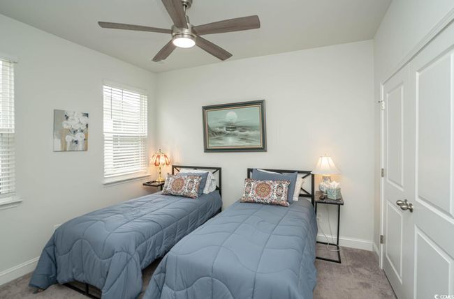 Carpeted bedroom with baseboards and a ceiling fan | Image 12