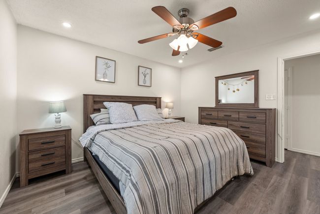 Bedroom featuring dark wood-type flooring, visible vents, a ceiling fan, and recessed lighting | Image 13