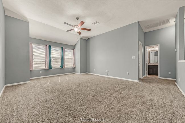 Unfurnished room featuring ceiling fan, lofted ceiling, and light carpet | Image 17