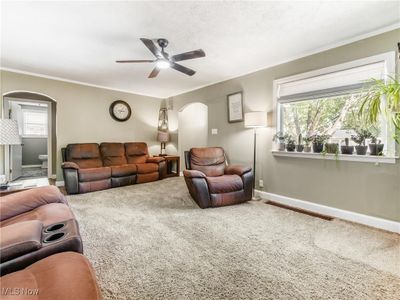 Living room featuring ornamental molding, ceiling fan, and carpet flooring | Image 3