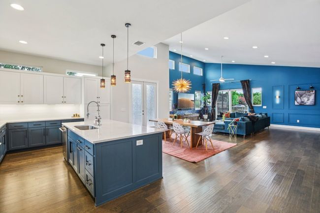 Kitchen featuring open floor plan, light countertops, french doors, recessed lighting, and decorative light fixtures | Image 14