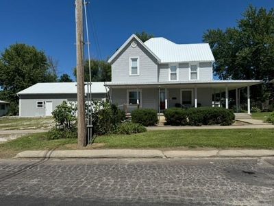 View of front facade with a front yard and a porch | Image 1