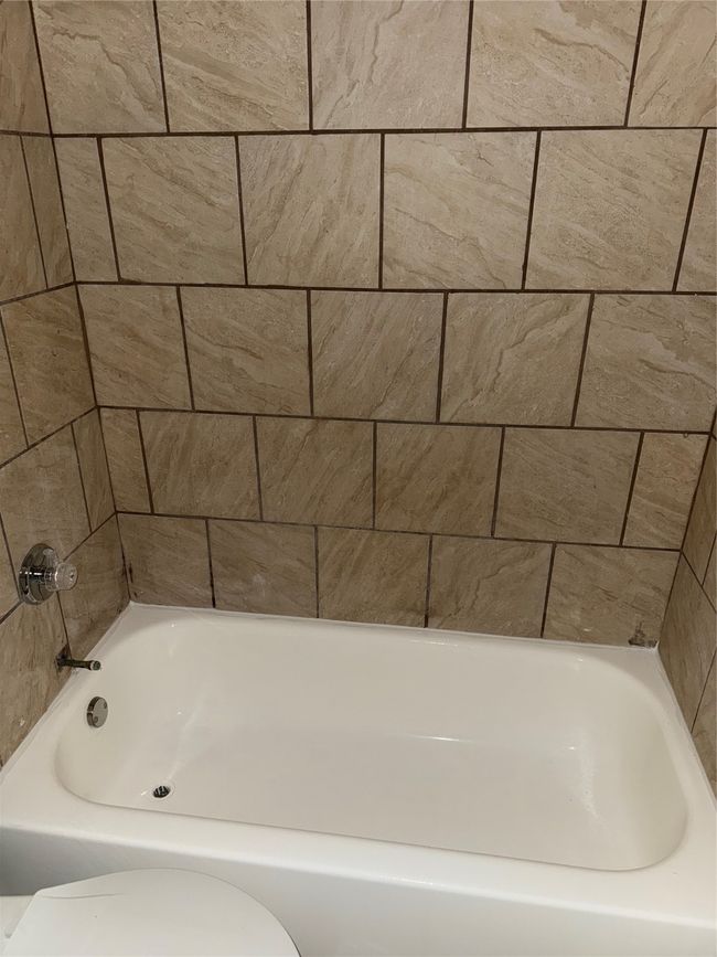 Bathroom with toilet and a bath | Image 6