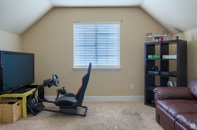Bedroom featuring lofted ceiling, carpet flooring, and baseboards | Image 25