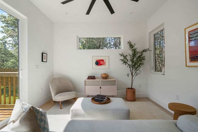 Living area with a ceiling fan, baseboards, and wood finished floors | Image 13