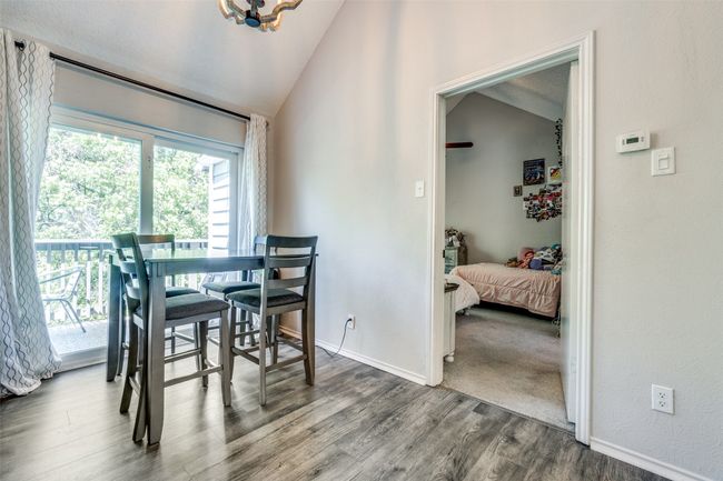 Dining room with lofted ceiling, wood finished floors, and baseboards | Image 17