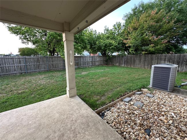 Fenced backyard with a patio | Image 38