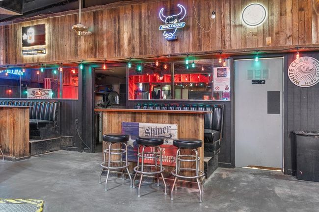 Indoor dry bar with concrete floors and wooden walls | Image 14
