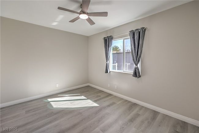 Empty room featuring wood finished floors, a ceiling fan, and baseboards | Image 27