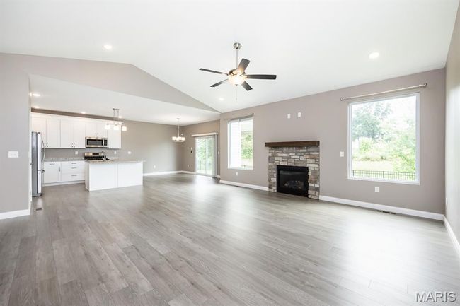 Stone, gas fireplace open to kitchen | Image 4