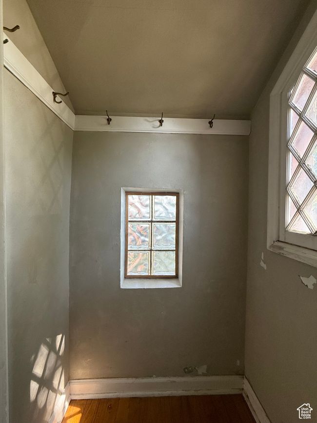 Spare room featuring wood finished floors, baseboards, and vaulted ceiling | Image 28