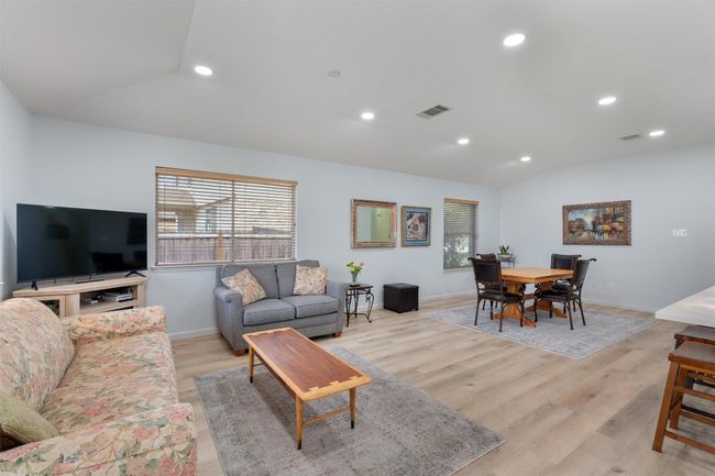 Living room featuring lofted ceiling, light wood finished floors, and recessed lighting | Image 9