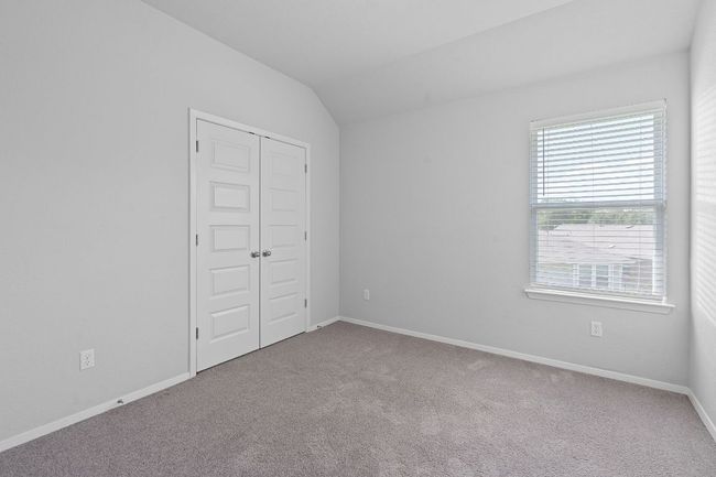 Unfurnished bedroom featuring carpet flooring, vaulted ceiling, and a closet | Image 26