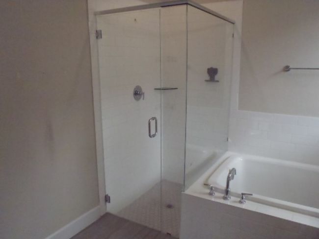 Bathroom featuring a garden tub and a shower stall | Image 28