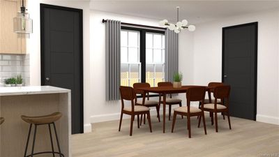 Dining area with a healthy amount of sunlight, light wood-type flooring, and a chandelier | Image 3