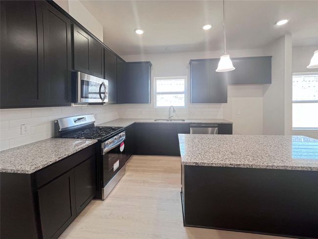 Kitchen with Island. Home under construction. Sample floor plan photo used for illustrative purposes only. Upgrades, selections options, windows and colors may vary. | Image 6