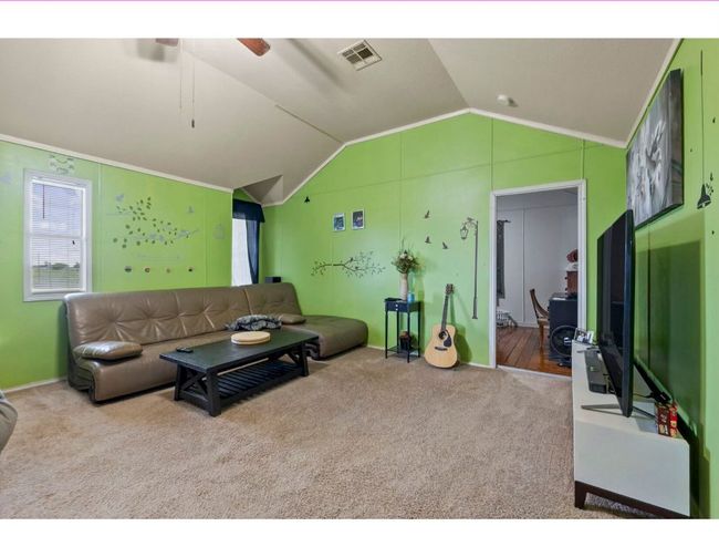 Living room with vaulted ceiling, carpet floors, and a ceiling fan | Image 36