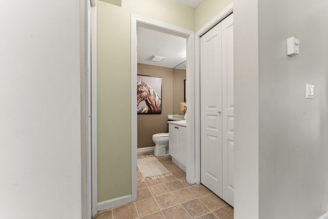Bathroom featuring tile patterned floors, toilet, vanity, a closet, and baseboards | Image 32