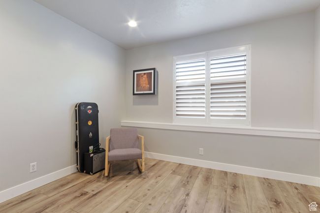 Sitting room with wood finished floors and baseboards | Image 28