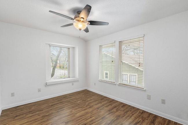 Spare room featuring baseboards, ceiling fan, and dark wood-style floors | Image 25