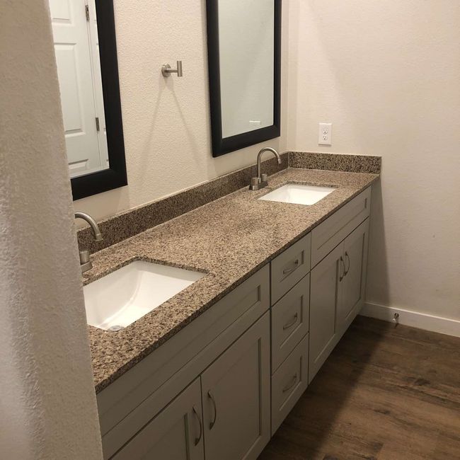 Bathroom with double vanity, wood finished floors, and baseboards | Image 18