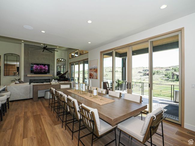 Dining area featuring recessed lighting, wood finished floors, ceiling fan, and a fireplace | Image 36