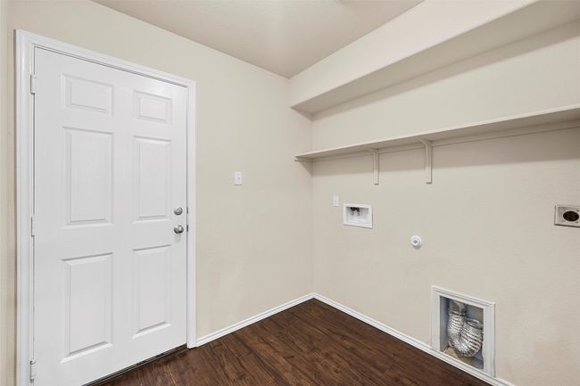 Laundry area featuring hookup for a washing machine, hookup for an electric dryer, dark wood-style floors, and gas dryer hookup | Image 23