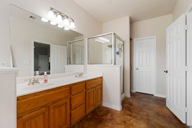 Dual vanities and a walk-in shower give the en suite bath everyday comfort with a luxe feel. | Image 21
