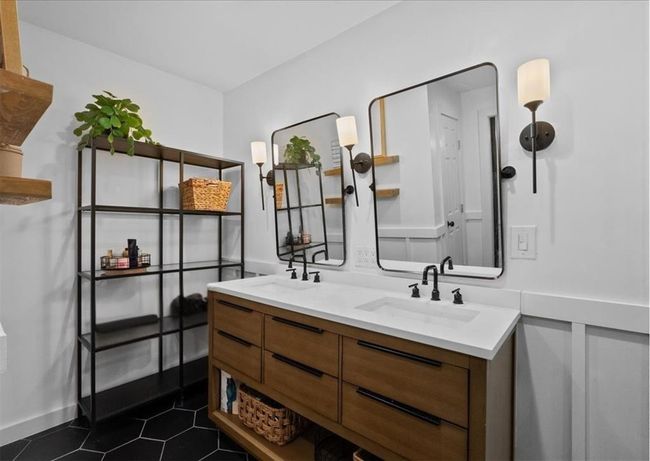 Dual vanity with modern fixtures and sleek wood cabinetry—style meets function. | Image 29