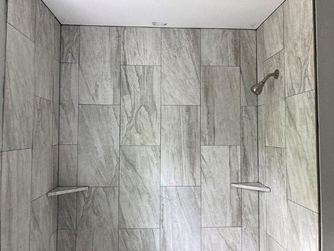 Bathroom view of a tile shower | Image 9