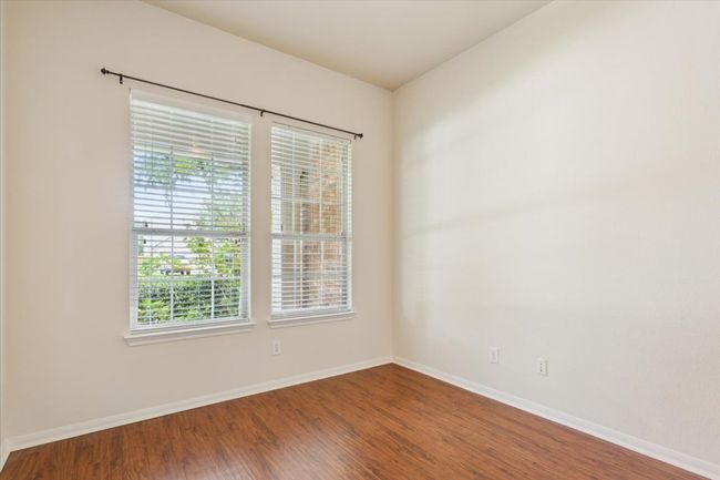 Empty room with plenty of natural light and wood finished floors | Image 30