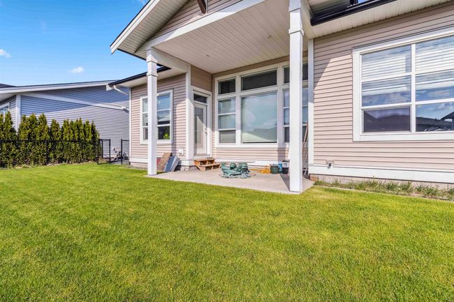 Back of property featuring fence, a patio area, entry steps, and a yard | Image 12