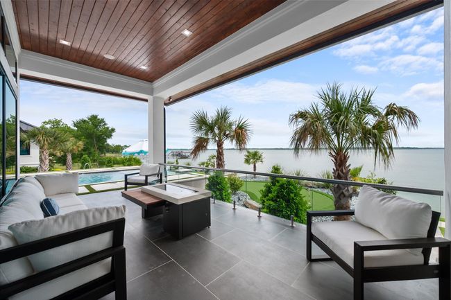 View of patio featuring an outdoor living space, a water view, and an outdoor pool | Image 24