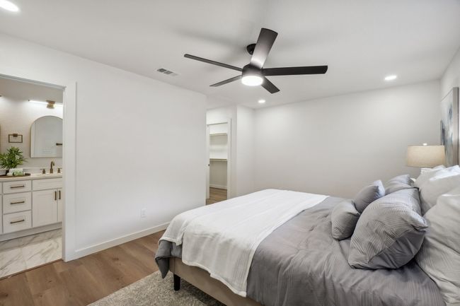 Bedroom with recessed lighting, ensuite bath, light wood-type flooring, a ceiling fan, and a walk in closet | Image 20