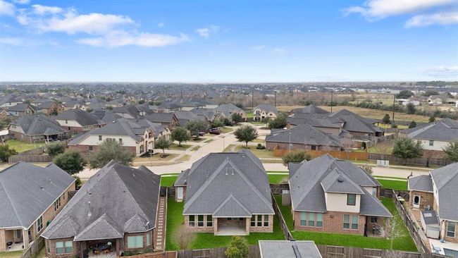 Enjoy the aerial view of the back of the home, showcasing the spacious backyard and the tranquil neighborhood that surrounds it. | Image 22