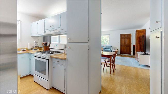 From back door of home, looking through kitchen to living room | Image 12