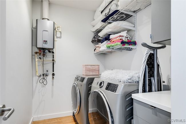 Large laundry room with high end appliances and ample shelving. | Image 35
